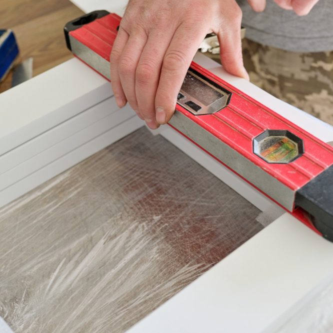 Furniture assembly. Carpenter using building level